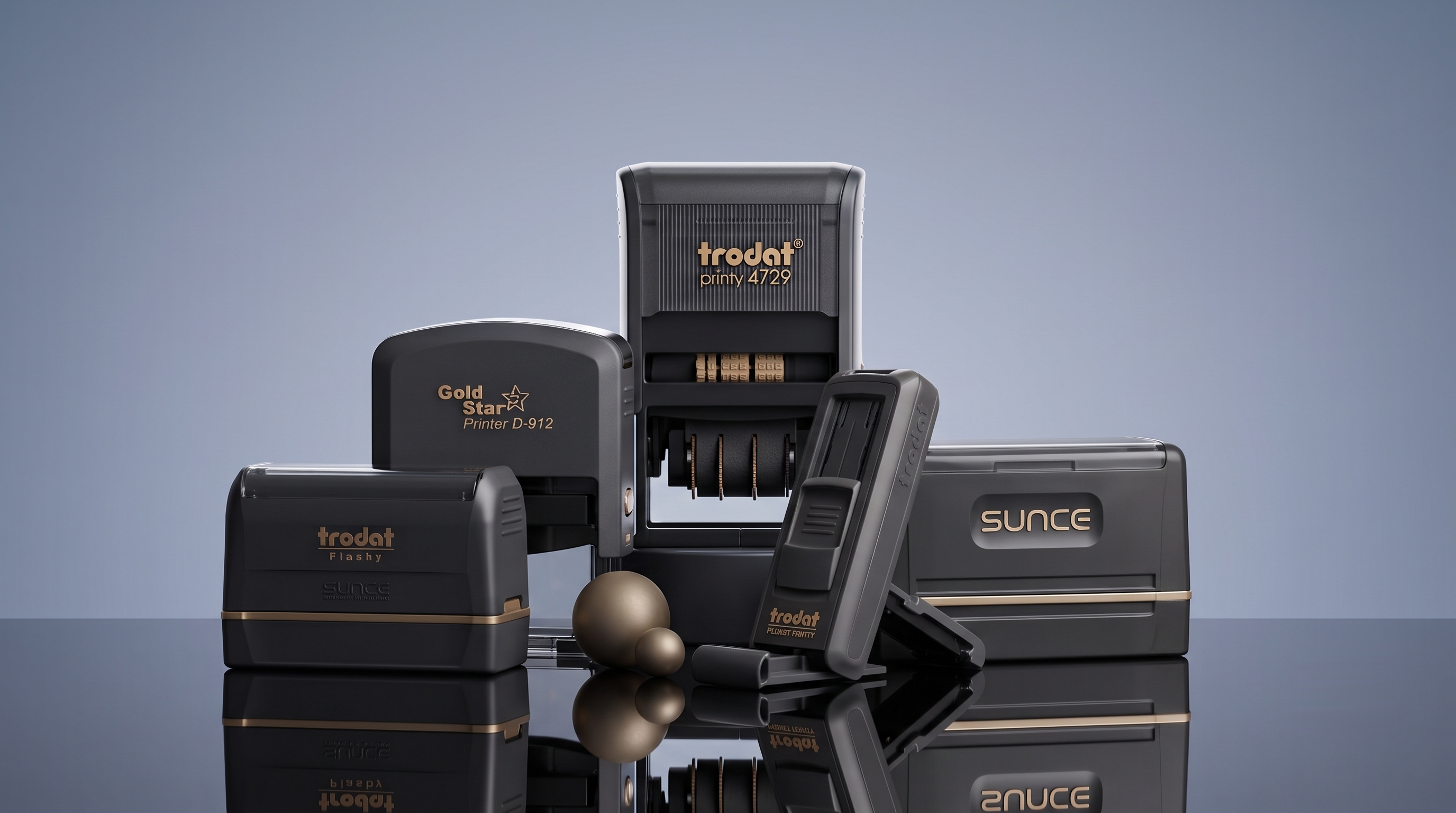 A curated arrangement of Bobby Rubber Stamp self-inking, dater, pocket and flash stamps in matte graphite with brass detailing